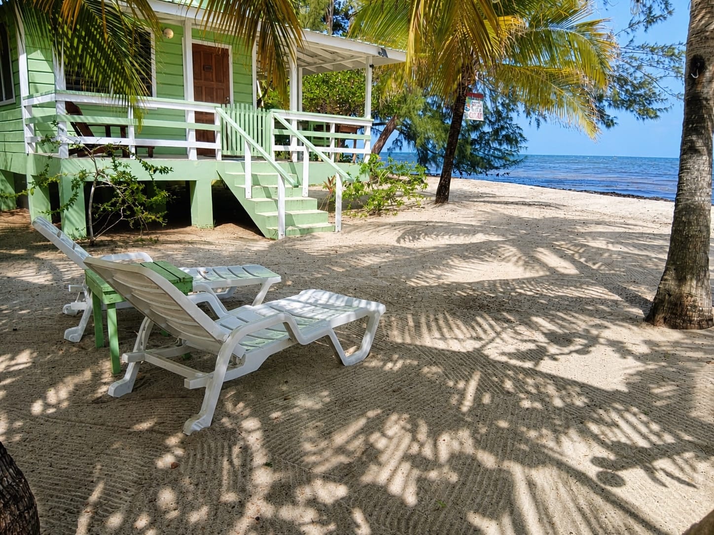 Beachfront cabana and loungers at The Village Inn